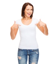Woman in a white shirt and jeans pointing to herself