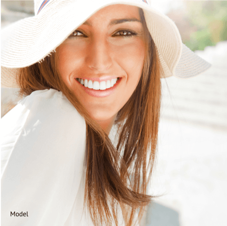 smiling woman with a white hat and shirt