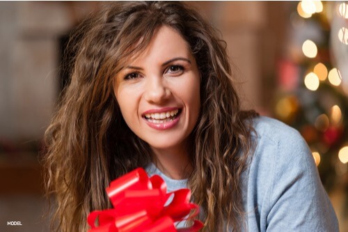 Girl holding a gift smiling