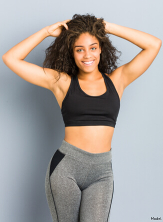 Confident woman in activewear touching her hair