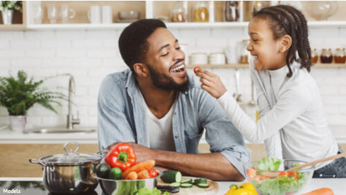 Daughter feeding her father food