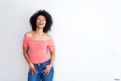 Woman standing against grey background