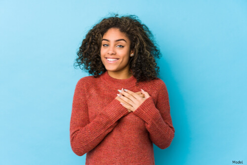 Woman with her hands on her heart