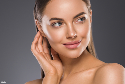 Woman with sleek, clear skin smiling