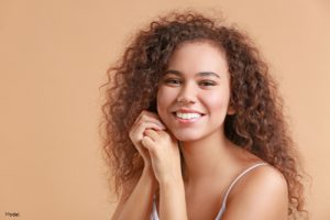 Woman with curly brown hair smiling