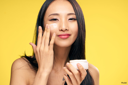 Woman applying skin care products to her face