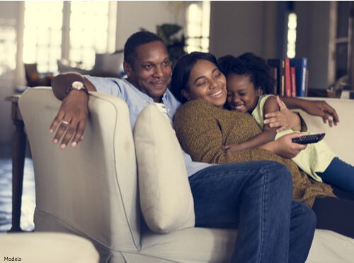 Family cuddling on the couch