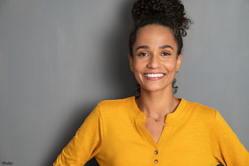 Woman smiling in a yellow shirt