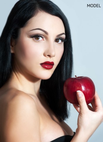 woman holding a red apple