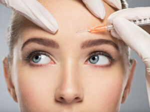 A young woman getting BOTOX® Cosmetic in her forehead