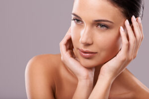 A woman touching her cheeks after Secret™ PRO skin resurfacing in Mill Valley