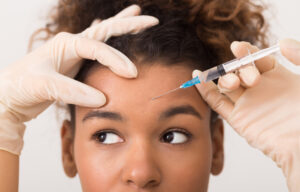 A woman getting BOTOX Cosmetic injections in her forehead
