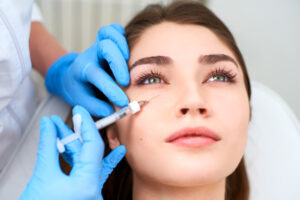 A woman getting hyaluronic acid filler under her eyes