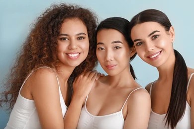 Three women smiling and showing the results of Secret RF microneedling in Mill Valley