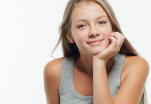 Teen girl smiling after AviClear™ laser acne treatment